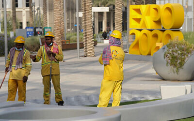 Workers clean an area at Expo 2020 in Dubai, United Arab Emirates, October 3, 2021. (AP Photo/Jon Gambrell, File)