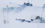 In this photo taken from video and released by the Russian Defense Ministry Press Service on February 2, 2022, Russian soldiers attend a military training at the Yurginsky training ground in the Kemerovo region, Russia. (Russian Defense Ministry Press Service via AP)
