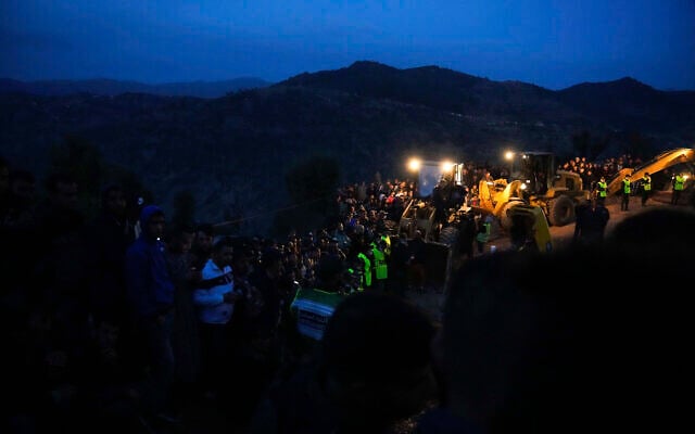 People stand next to tractors at nightfall as they observe a rescue mission of a 5-year-old boy who fell into a hole in the northern village of Ighran in Morocco's Chefchaouen province, on February 4, 2022. (AP Photo/Mosa'ab Elshamy) People stand next to tractors at nightfall as they observe a rescue mission of a 5-year-old boy who fell into a hole in the northern village of Ighran in Morocco's Chefchaouen province, on February 4, 2022. (AP Photo/Mosa'ab Elshamy)