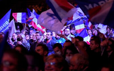 Supporters of French far right presidential candidate Marine Le Pen wave flags during a campaign rally, Feb. 5, 2022 in Reims, eastern France (AP Photo/Michel Euler)