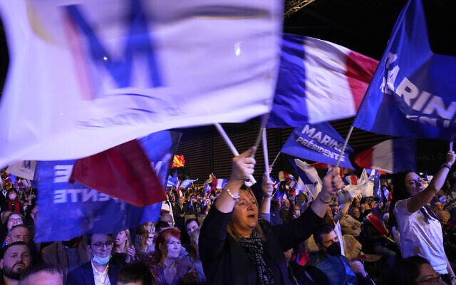 Supporters of French far-right presidential candidate Marine Le Pen wave flags during a campaign rally, February 5, 2022, in Reims, eastern France. (AP Photo/Michel Euler) Supporters of French far-right presidential candidate Marine Le Pen wave flags during a campaign rally, February 5, 2022, in Reims, eastern France. (AP Photo/Michel Euler)