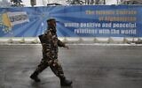 A Taliban fighter with his gun walks on a street, in Kabul, Afghanistan, Sunday, Feb. 6, 2022. (AP Photo/Hussein Malla)