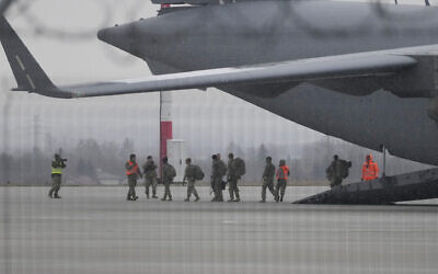 US Army troops of the 82nd Airborne Division unloading vehicles from a transport plane after arriving from Fort Bragg, at the Rzeszow-Jasionka airport in southeastern Poland, on February 6, 2022. (AP Photo/Czarek Sokolowski)