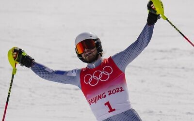 Barnabas Szollos, of Israel, celebrates after finishing the slalom run of the men's combined at the 2022 Winter Olympics, Feb. 10, 2022, in the Yanqing district of Beijing. (AP Photo/Luca Bruno)