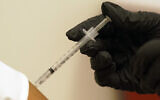 A person is injected with her second dose of the Pfizer COVID-19 vaccine at a Dallas County Health and Human Services vaccination site in Dallas, Texas, on August 26, 2021. (AP Photo/LM Otero, File)