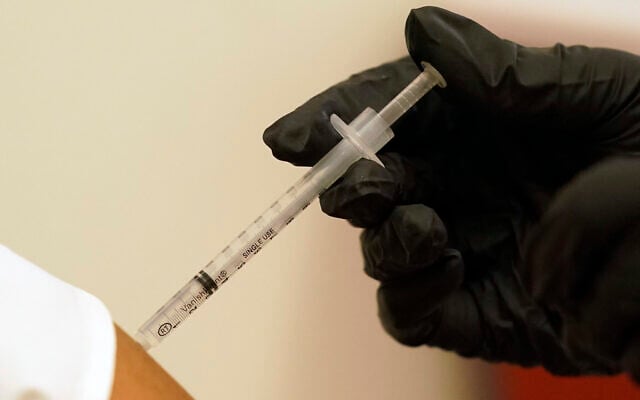 A person is injected with her second dose of the Pfizer COVID-19 vaccine at a Dallas County Health and Human Services vaccination site in Dallas, Texas, on August 26, 2021. (AP Photo/LM Otero, File)