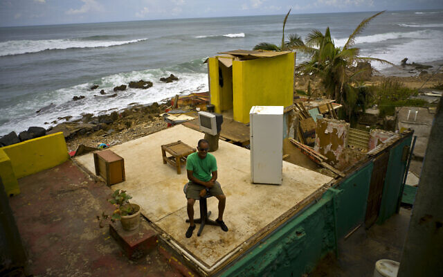 Roberto Figueroa Caballero sits on a small table in his home that was destroyed by Hurricane Maria in La Perla neighborhood on the coast of San Juan, Puerto Rico, on Oct. 5, 2017. (AP Photo/Ramon Espinosa, File) Roberto Figueroa Caballero sits on a small table in his home that was destroyed by Hurricane Maria in La Perla neighborhood on the coast of San Juan, Puerto Rico, on Oct. 5, 2017. (AP Photo/Ramon Espinosa, File)