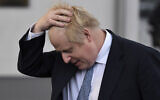 British Prime Minister Boris Johnson gestures as he speaks to the media during a visit to the Warszawska Brygada Pancerna military base near Warsaw, Poland, February 10, 2022. (Daniel Leal/Pool via AP, File)