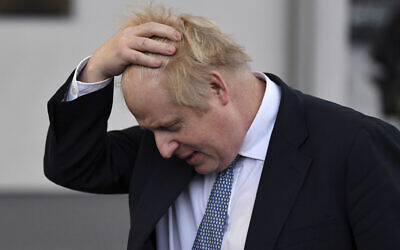 British Prime Minister Boris Johnson gestures as he speaks to the media during a visit to the Warszawska Brygada Pancerna military base near Warsaw, Poland, February 10, 2022. (Daniel Leal/Pool via AP, File)