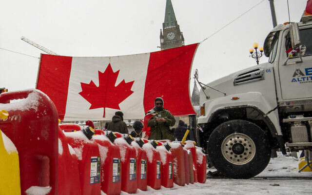 Gas cans sit in a row during a demonstration against COVID-19 restrictions on Parliament Hill, in Ottawa, Feb. 12, 2022. (Frank Gunn /The Canadian Press via AP)