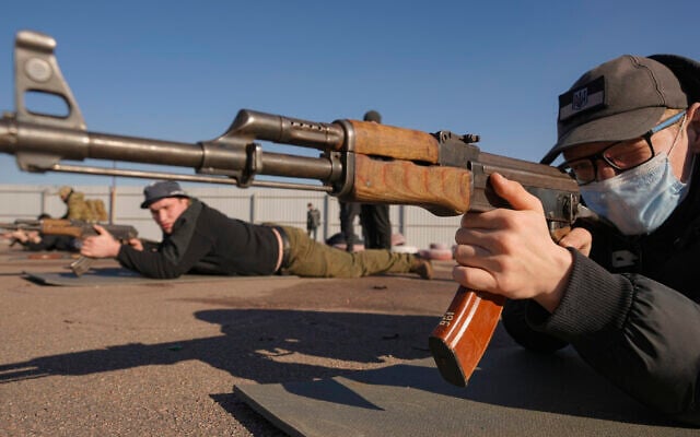 Men hold weapons during a basic combat training for civilians, organized by the Special Forces Unit Azov, of Ukraine's National Guard, in Mariupol, Donetsk region, eastern Ukraine, February 13, 2022. (AP Photo/Vadim Ghirda)