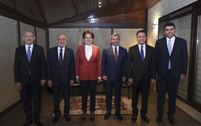 From left, Turkey's main opposition Republican People's Party (CHP) leader Kemal Kilicdaroglu, Felicity Party leader Temel Karamollaoglu, Good Party leader Meral Aksener, Future Party leader Ahmet Davutoglu, Democracy and Progress Party leader Ali Babacan and Democrat Party leader Gultekin Uysal pose for photos before their meeting in Ankara, Turkey, Feb. 12, 2022. (Alp Eren Kaya/CHP via AP)