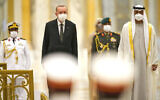 Turkish President Recep Tayyip Erdogan, center left, and Abu Dhabi Crown Prince Sheikh Mohammed bin Zayed Al Nahyan, right, stand for an honor guard at Qasr Al-Watan in Abu Dhabi, United Arab Emirates, Feb. 14, 2022. (Jon Gambrell/AP)