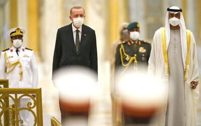 Turkish President Recep Tayyip Erdogan, center left, and Abu Dhabi Crown Prince Sheikh Mohammed bin Zayed Al Nahyan, right, stand for an honor guard at Qasr Al-Watan in Abu Dhabi, United Arab Emirates, Feb. 14, 2022. (Jon Gambrell/AP)