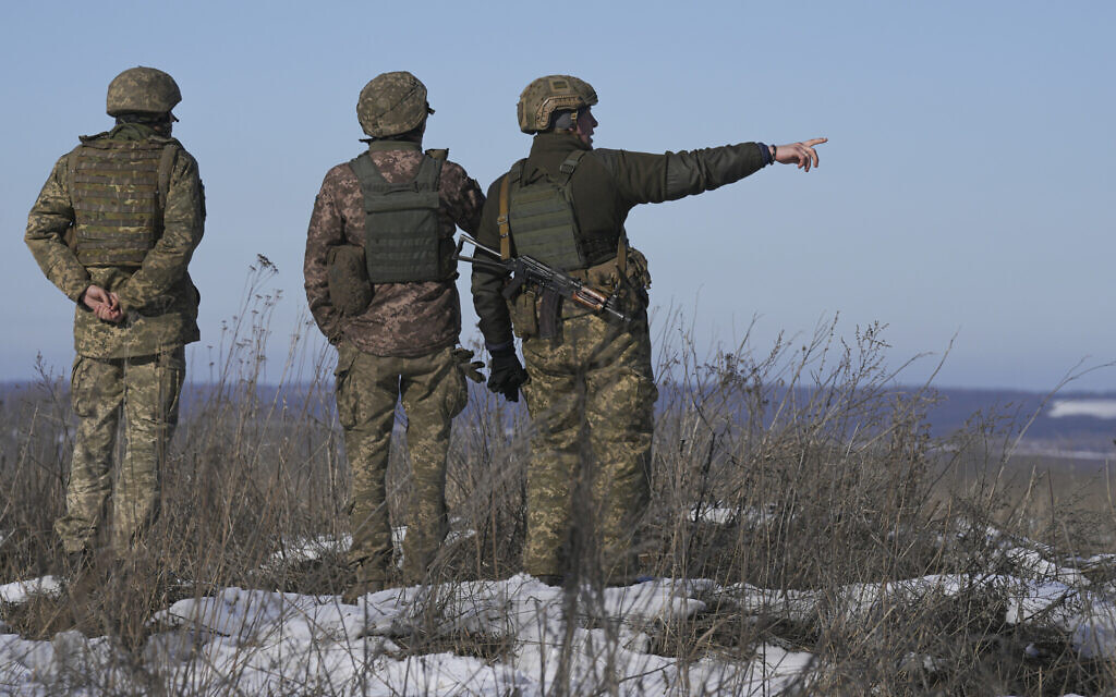 Ukrainian servicemen survey the impact areas from shells that landed close to their positions during the night on a front line outside Popasna, Luhansk region, eastern Ukraine, on February 14, 2022. (AP/Vadim Ghirda) Ukrainian servicemen survey the impact areas from shells that landed close to their positions during the night on a front line outside Popasna, Luhansk region, eastern Ukraine, on February 14, 2022. (AP/Vadim Ghirda)