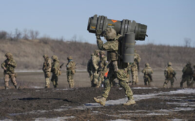 A Ukrainian serviceman carries an NLAW anti-tank weapon during an exercise in the Joint Forces Operation, in the Donetsk region, eastern Ukraine, February 15, 2022. (AP/Vadim Ghirda, File)