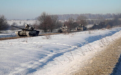 In this photo taken from video provided by the Russian Defense Ministry Press Service on Feb. 15, 2022, Russian army tanks move back to their permanent base after drills in Russia (Russian Defense Ministry Press Service via AP)