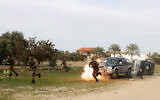 Actors wearing Hamas uniforms in an action scene as a crew from the Hamas-run al-Aqsa satellite channel shoots for a 30-episode series, titled 'Fist of the Free,' in Beit Lahiya, northern Gaza Strip, Feb. 3, 2022. (Adel Hana/AP)
