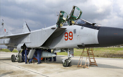 A MiG-31 fighter jet of the Russian air force carrying a Kinzhal hypersonic cruise missile is parked at the Hemeimeem air base in Syria, February 15, 2022. (Russian Defense Ministry Press Service via AP)