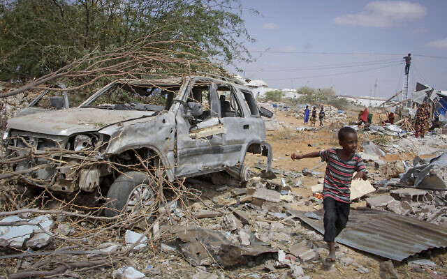 A young boy runs past the wreckage of a vehicle destroyed in an attack on police and checkpoints on the outskirts of the capital Mogadishu, Somalia Wednesday, Feb. 16, 2022. (AP Photo/Farah Abdi Warsameh) A young boy runs past the wreckage of a vehicle destroyed in an attack on police and checkpoints on the outskirts of the capital Mogadishu, Somalia Wednesday, Feb. 16, 2022. (AP Photo/Farah Abdi Warsameh)