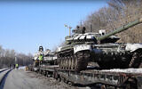 Russian army tanks are loaded onto railway platforms to move back to their permanent base after drills in Russia, February 16, 2022. (Russian Defense Ministry Press Service via AP)