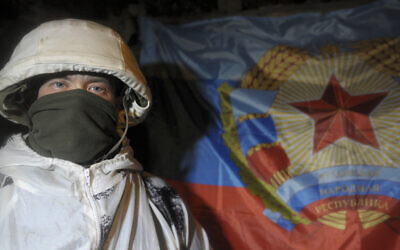 A serviceman of the self-declared Luhansk republic poses for a photographer in a shelter on the territory controlled by pro-Russian militants at the frontline with Ukrainian government forces in Slavyanoserbsk, Luhansk region, eastern Ukraine, on February 3, 2022. (AP Photo/Alexei Alexandrov, File)