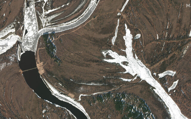 This February 15, 2022 satellite image provided by Maxar Technologies shows an overview of road construction and new pontoon bridge over the Pripyat River, Belarus. (Satellite image ©2022 Maxar Technologies via AP) This February 15, 2022 satellite image provided by Maxar Technologies shows an overview of road construction and new pontoon bridge over the Pripyat River, Belarus. (Satellite image ©2022 Maxar Technologies via AP)