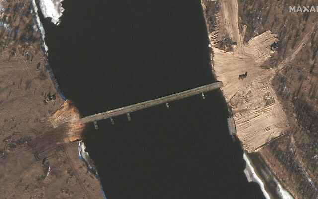 This February 15, 2022 satellite image provided by Maxar Technologies shows an overview of road construction and new pontoon bridge over the Pripyat River, Belarus. (Satellite image ©2022 Maxar Technologies via AP) This February 15, 2022 satellite image provided by Maxar Technologies shows an overview of road construction and new pontoon bridge over the Pripyat River, Belarus. (Satellite image ©2022 Maxar Technologies via AP)