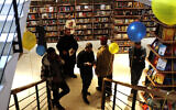People browse bookshelves at the Samir Mansour Bookstore during a re-opening ceremony in Gaza City, on February 17, 2022. (AP Photo/Adel Hana)