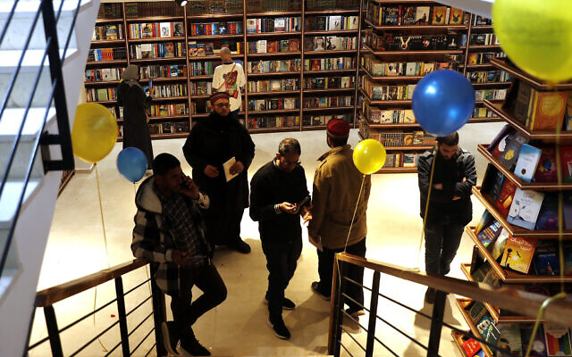 People browse bookshelves at the Samir Mansour Bookstore during a re-opening ceremony in Gaza City, on February 17, 2022. (AP Photo/Adel Hana) People browse bookshelves at the Samir Mansour Bookstore during a re-opening ceremony in Gaza City, on February 17, 2022. (AP Photo/Adel Hana)
