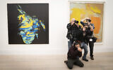 Photographers take photos near to the artwork Andy Warhol, Self-Portrait, 1986, during a photocall for artworks from the Macklowe Collection at Sotheby's, prior to the collection being offered at auction in New York, in London, on February 18, 2022. (Stefan Rousseau/PA via AP)