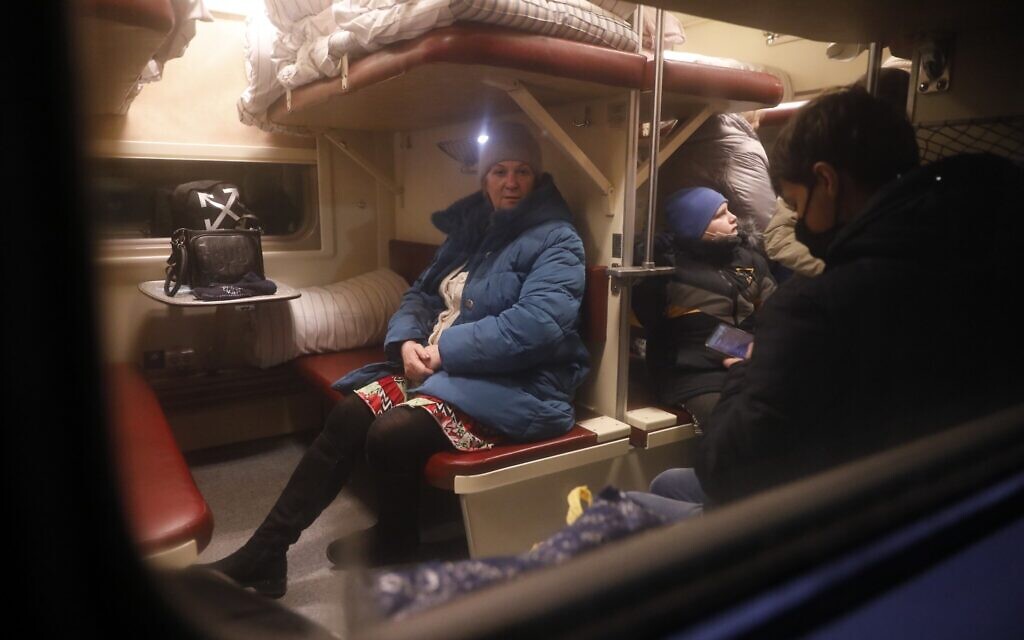 People from Donetsk and Luhansk regions, the territory controlled by a pro-Russia separatist governments in eastern Ukraine, sit a train carriage waiting to be taken to temporary residences in the Volgograd region, at the railway station in Volzhsky, Volgograd region, Russia, Feb. 20, 2022. (Alexandr Kulikov/AP)