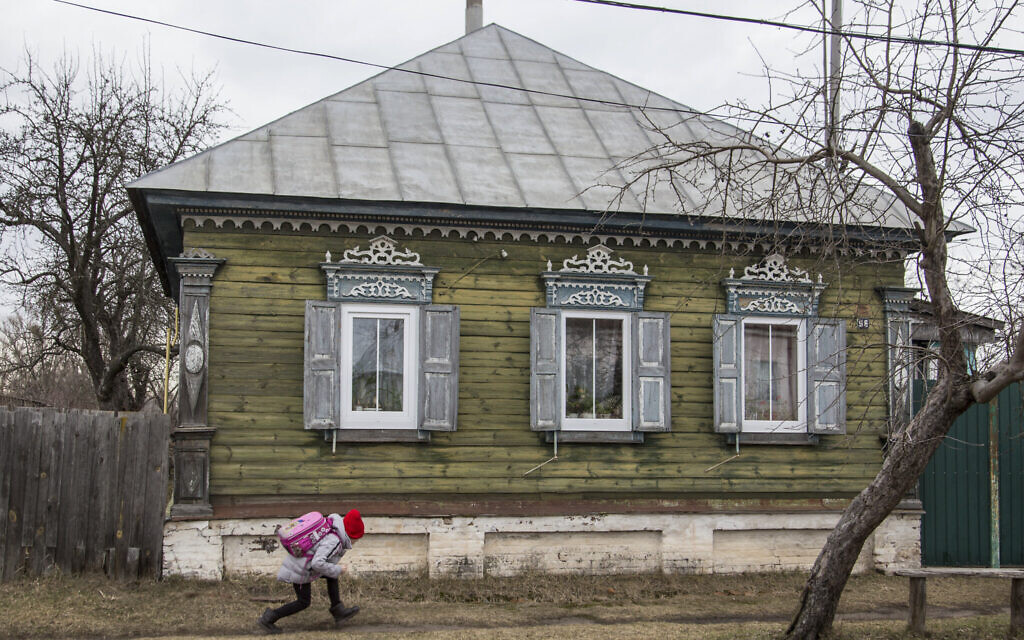 A schoolgirl runs in Ukraine's village of Dobryanka close to the Belarus border, Feb. 21, 2022. (AOleksandr Ratushniak/AP)