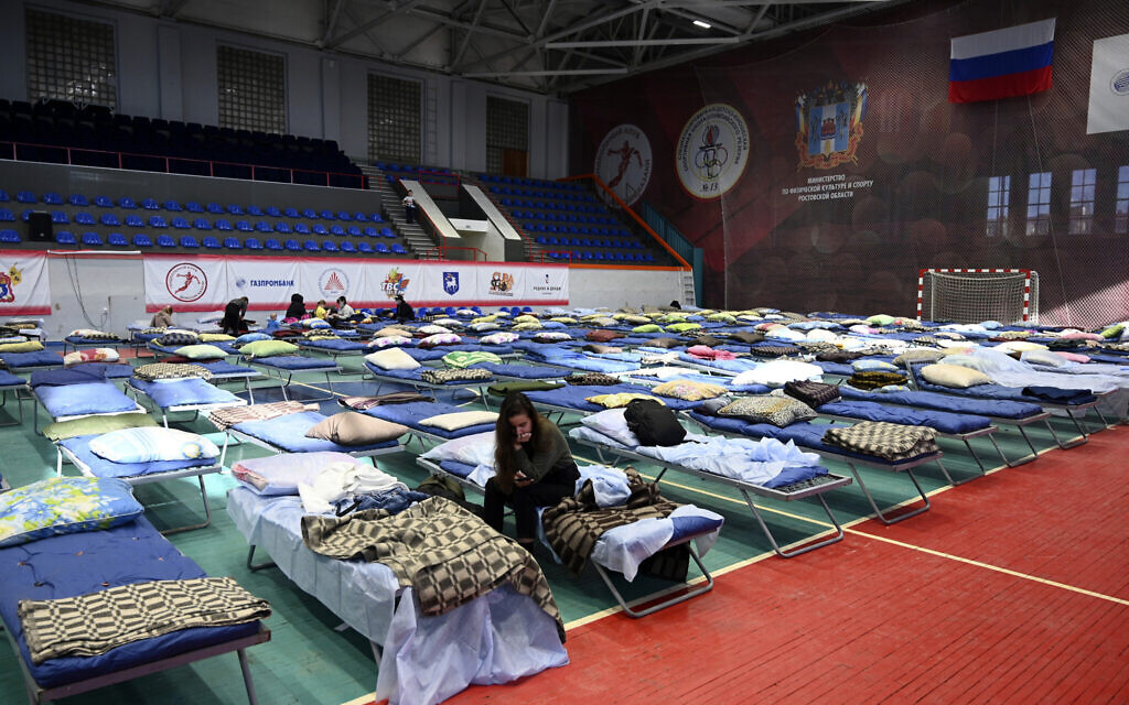 Displaced civilians from the Donetsk and Luhansk regions, the territory controlled by pro-Russia separatist governments in eastern Ukraine, rest in a sport hall in Taganrog, Russia, Feb. 21, 2022. (AP Photo)