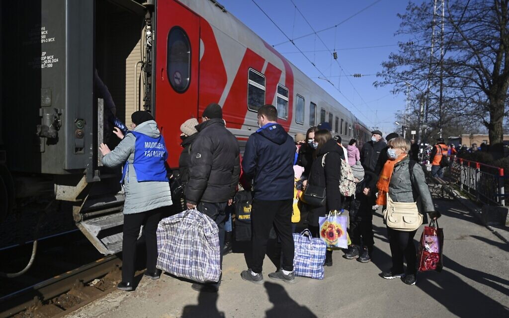 People from the Donetsk and Luhansk regions, the territory controlled by pro-Russia separatist governments in eastern Ukraine, get on a train to be taken to temporary residences in other regions of Russia, at the railway station in Taganrog, Russia, Feb. 21, 2022. (AP Photo)
