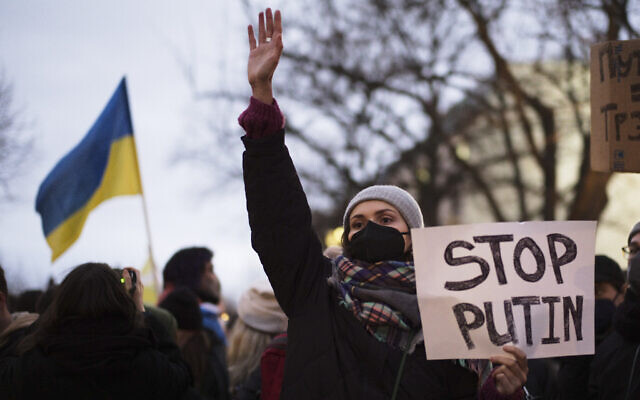 A woman shows a poster in support of Ukraine at a demonstration along the street near the Russian embassy to protest against the escalation of the tension between Russia and Ukraine in Berlin, Germany, on Tuesday, February 22, 2022. (AP Photo/Markus Schreiber) A woman shows a poster in support of Ukraine at a demonstration along the street near the Russian embassy to protest against the escalation of the tension between Russia and Ukraine in Berlin, Germany, on Tuesday, February 22, 2022. (AP Photo/Markus Schreiber)