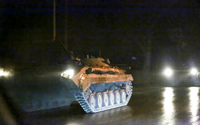 An armored vehicle rolls down a street outside Donetsk, the territory controlled by pro-Russian militants, eastern Ukraine, on February 22, 2022. (AP Photo) An armored vehicle rolls down a street outside Donetsk, the territory controlled by pro-Russian militants, eastern Ukraine, on February 22, 2022. (AP Photo)