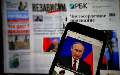 The app of the Russian government newspaper is displayed on an iPhone screen showing Russian President Vladimir Putin during his speech in the Kremlin in Moscow, Russia, on Tuesday, February 22, 2022. (AP Photo/Alexander Zemlianichenko Jr) The app of the Russian government newspaper is displayed on an iPhone screen showing Russian President Vladimir Putin during his speech in the Kremlin in Moscow, Russia, on Tuesday, February 22, 2022. (AP Photo/Alexander Zemlianichenko Jr)