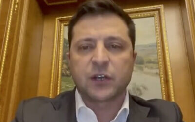 In this handout photo taken from video provided by the Ukrainian Presidential Press Office, Ukrainian President Volodymyr Zelensky addresses the nation in Kyiv, Ukraine, Thursday, Feb. 24, 2022. Zelensky declared martial law, saying Russia has targeted Ukraine's military infrastructure. He urged Ukrainians to stay home and not to panic. (Ukrainian Presidential Press Office via AP) In this handout photo taken from video provided by the Ukrainian Presidential Press Office, Ukrainian President Volodymyr Zelensky addresses the nation in Kyiv, Ukraine, Thursday, Feb. 24, 2022. Zelensky declared martial law, saying Russia has targeted Ukraine's military infrastructure. He urged Ukrainians to stay home and not to panic. (Ukrainian Presidential Press Office via AP)