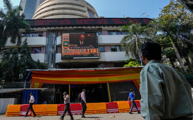 A man watches a screen showing a news item featuring Russian President Vladimir Putin on the facade of the Bombay Stock Exchange (BSE) building in Mumbai, India, on Thursday, February 24, 2022. (AP Photo/Rafiq Maqbool) A man watches a screen showing a news item featuring Russian President Vladimir Putin on the facade of the Bombay Stock Exchange (BSE) building in Mumbai, India, on Thursday, February 24, 2022. (AP Photo/Rafiq Maqbool)