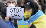 People attend a pro-Ukraine protest rally in front of the Brandenburg Gate in Berlin, Germany, February 24, 2022 after Russian troops have launched their anticipated attack on Ukraine. (AP Photo/Michael Sohn)