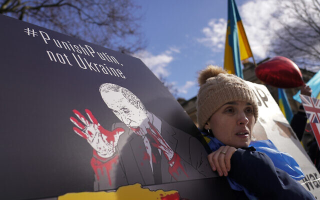 A demonstrator holds a placard as she attends a demonstration outside Downing Street, in London, February 24, 2022. (AP Photo/Alberto Pezzali) A demonstrator holds a placard as she attends a demonstration outside Downing Street, in London, February 24, 2022. (AP Photo/Alberto Pezzali)