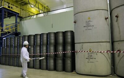 In this March 23, 2016, photo, a worker checks the radiation level on barrels in a storage of nuclear waste taken from the 4th unit destroyed by explosion at the Chernobyl nuclear power plant, Chernobyl, Ukraine. (AP Photo/Efrem Lukatsky, File)