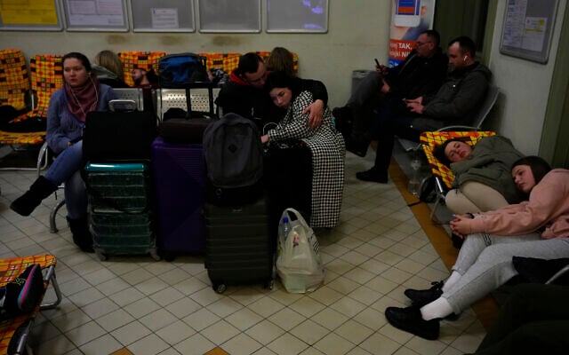 People from neighboring Ukraine rest at a train station that was turned into an accommodation center in Przemysl, Poland, on February 24, 2022. (AP Photo/Petr David Josek)