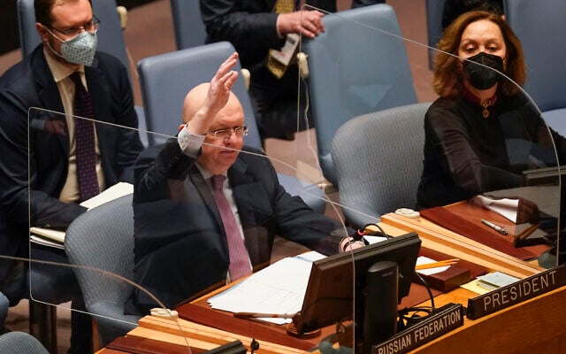 Vasily Nebenzya, Russian ambassador to the United Nations, participates in a vote during a Security Council meeting at United Nations headquarters, Friday, Feb. 25, 2022. (AP Photo/Seth Wenig)