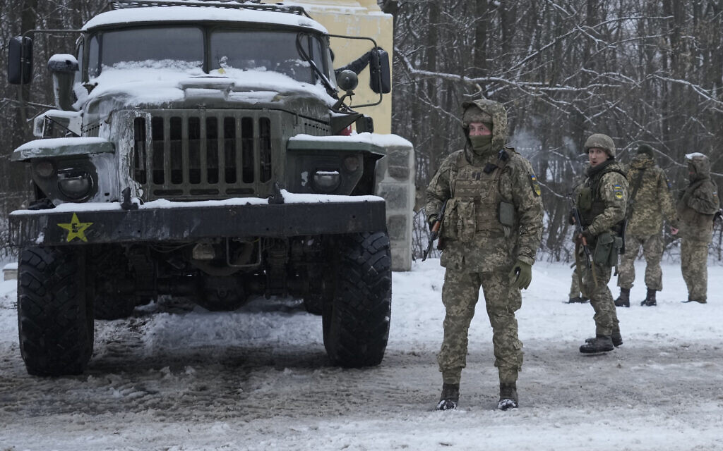 Ukrainian servicemen stand by a deactivated Russian military multiple rocket launcher on the outskirts of Kharkiv, Ukraine, on Friday, February 25, 2022. Russian troops bore down on Ukraine's capital Friday, with gunfire and explosions resonating ever closer to the government quarter, in an invasion of a democratic country that has fueled fears of wider war in Europe and triggered worldwide efforts to make Russia stop. (AP Photo/Vadim Ghirda)