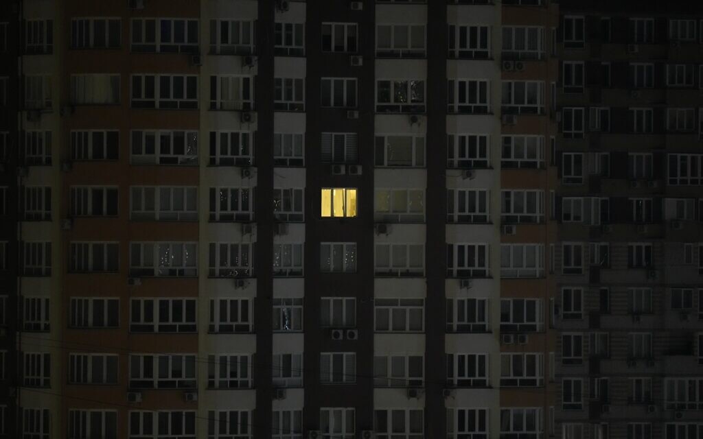 An illuminated window on a residential building with the rest of the lighting turned off for safety reasons, in the city of Kyiv, February 25, 2022. (AP Photo/Efrem Lukatsky)