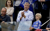 Chelsea's owner Roman Abramovich, center, applauds after Chelsea were presented with the Premier League trophy after their English Premier League soccer match against Sunderland at Stamford Bridge stadium in London, on May 24, 2015. (AP Photo/Matt Dunham, file)