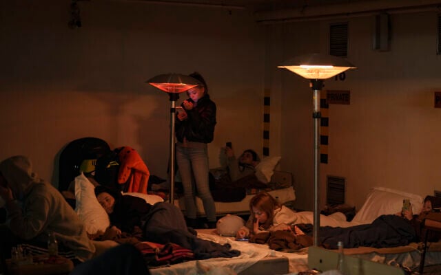 People lie on mattresses in the underground parking lot of a hotel that has been turned into a bomb shelter during an air raid alert in Kyiv, Ukraine, Feb. 27, 2022. (Vadim Ghirda/AP) People lie on mattresses in the underground parking lot of a hotel that has been turned into a bomb shelter during an air raid alert in Kyiv, Ukraine, Feb. 27, 2022. (Vadim Ghirda/AP)