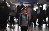 A refugee boy who fled conflict from neighboring Ukraine cries at the railway station after arriving at Zahony, Hungary, February 27, 2022. (AP Photo/Anna Szilagyi)